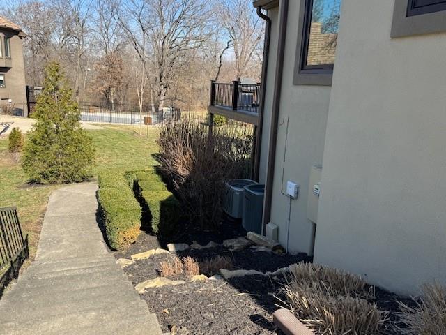 view of yard featuring cooling unit and fence