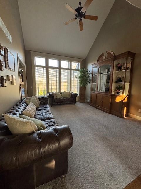 living room with high vaulted ceiling, ceiling fan, and carpet floors