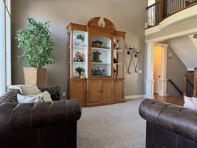 carpeted living room featuring baseboards