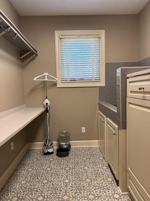 laundry area with baseboards