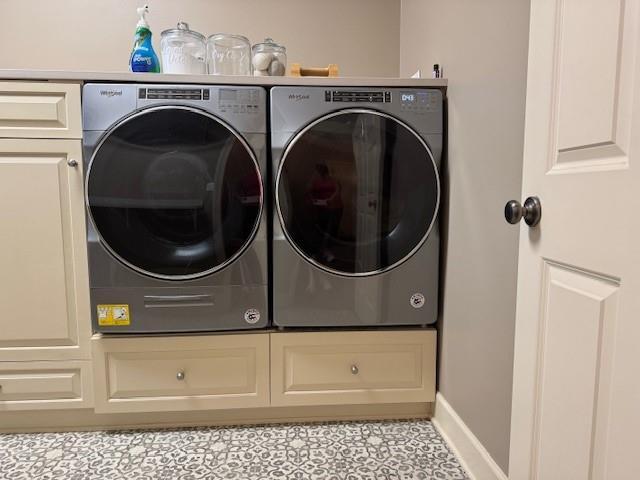 laundry area with washer and dryer, cabinet space, and baseboards