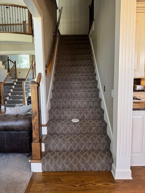 stairs featuring baseboards and wood finished floors