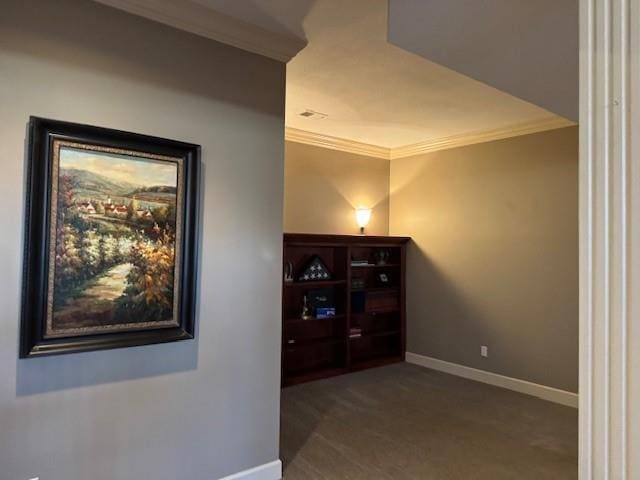 hall featuring carpet flooring, baseboards, and crown molding