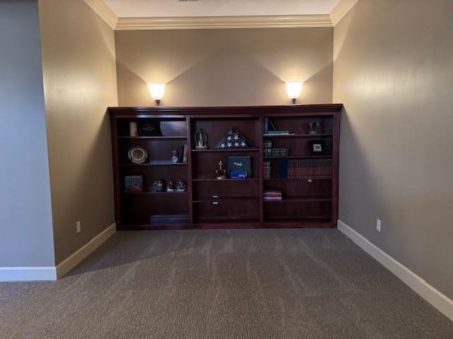 interior space featuring baseboards and ornamental molding