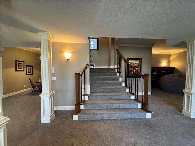 staircase featuring crown molding, baseboards, carpet, decorative columns, and a textured ceiling