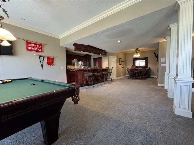 rec room with decorative columns, ornamental molding, bar area, a textured ceiling, and light colored carpet