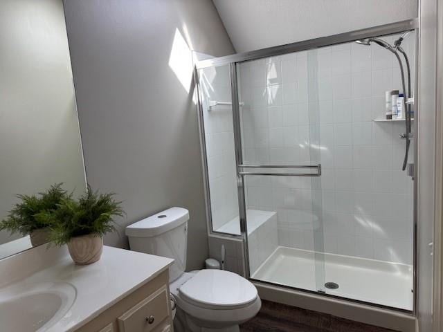 full bath with vanity, toilet, and a stall shower