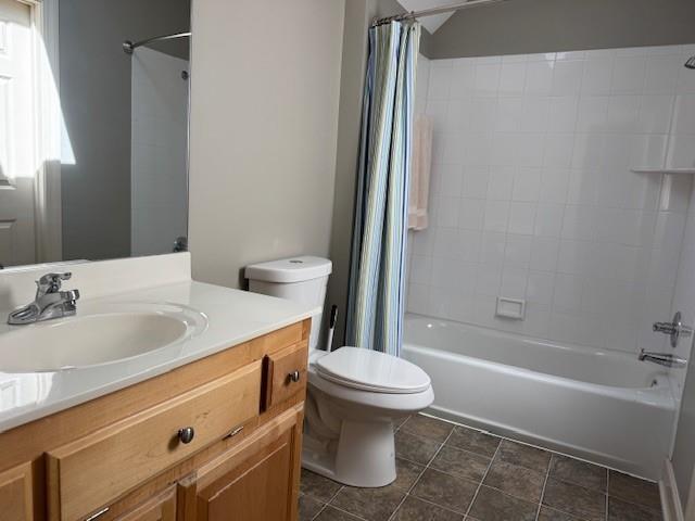 bathroom featuring vanity, shower / bath combination with curtain, toilet, and tile patterned flooring