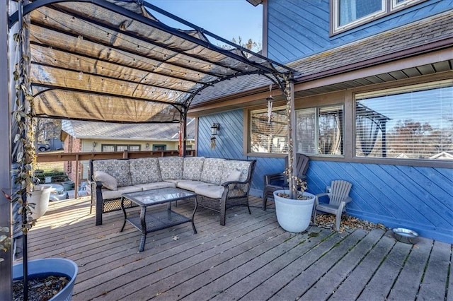 wooden terrace with an outdoor living space and a pergola