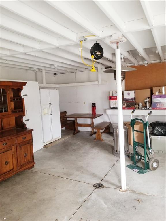 garage with white fridge with ice dispenser