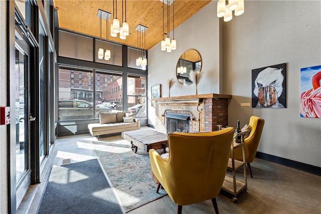 living room featuring baseboards, a chandelier, wood ceiling, a textured wall, and high vaulted ceiling