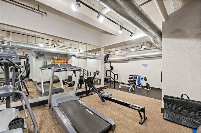 gym featuring track lighting