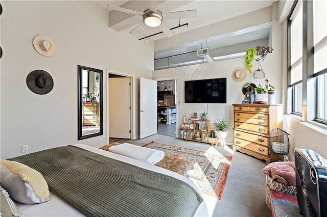 bedroom featuring visible vents and a high ceiling