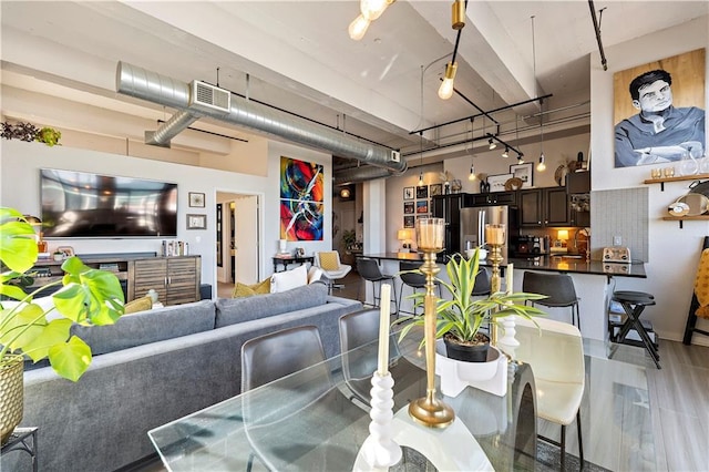 dining area with visible vents and a towering ceiling