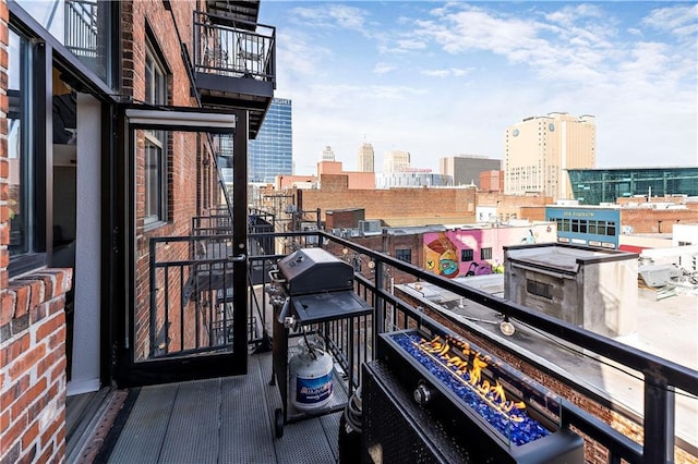 balcony featuring a city view and grilling area