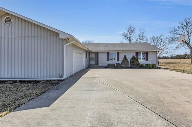 ranch-style home featuring an attached garage and concrete driveway