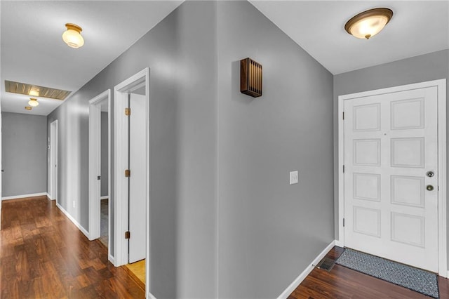 foyer with visible vents, baseboards, and wood finished floors