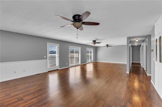 unfurnished living room with ceiling fan and wood finished floors