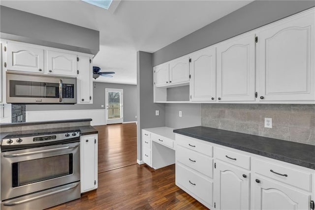 kitchen featuring ceiling fan, decorative backsplash, dark wood-type flooring, white cabinets, and appliances with stainless steel finishes