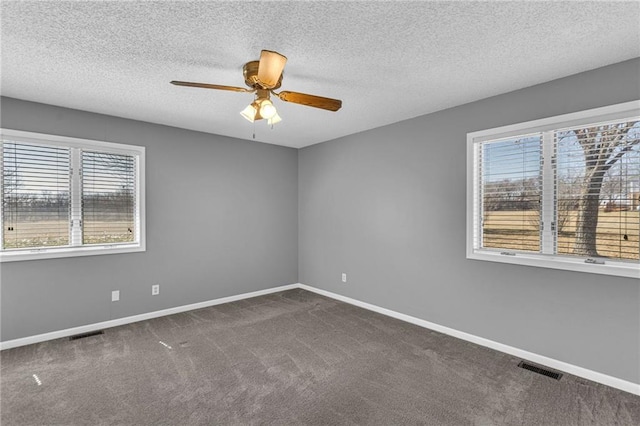 unfurnished room featuring visible vents, baseboards, ceiling fan, and carpet flooring