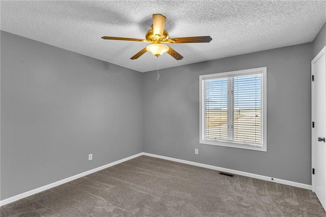 empty room featuring visible vents, carpet floors, baseboards, and ceiling fan