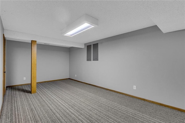 finished basement featuring carpet flooring, baseboards, and a textured ceiling