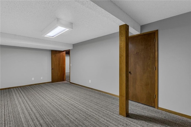 finished basement with baseboards, carpet floors, and a textured ceiling