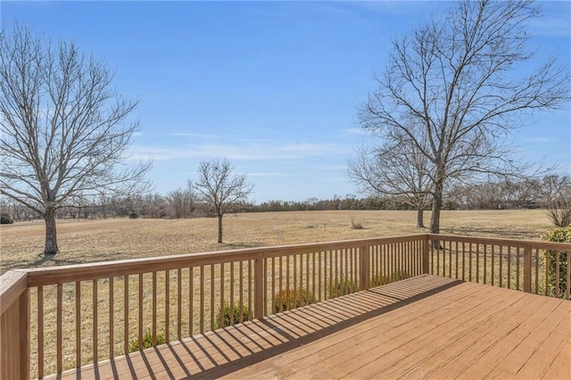 wooden deck with a rural view