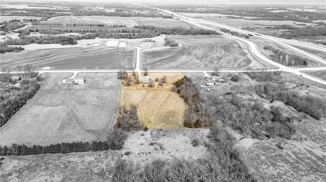 birds eye view of property with a rural view