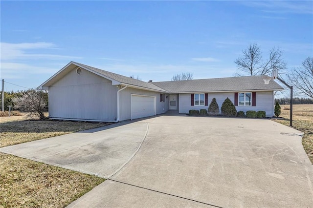 single story home featuring concrete driveway and a garage