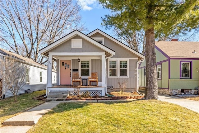 bungalow-style home with a porch, a front lawn, and board and batten siding