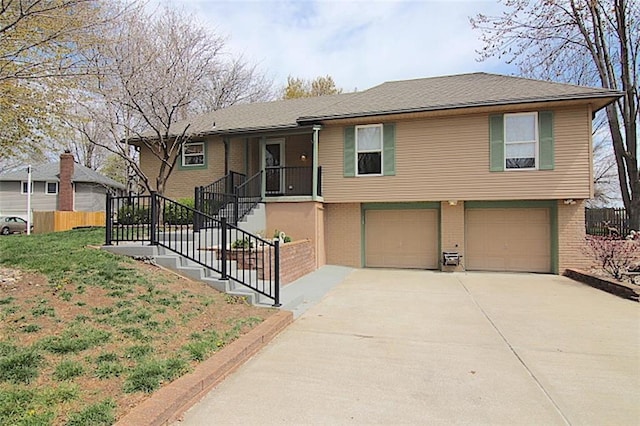 225 N Woodson Dr, Raymore, MO 64083 - view of front facade with an attached garage, driveway, stairs, and brick siding