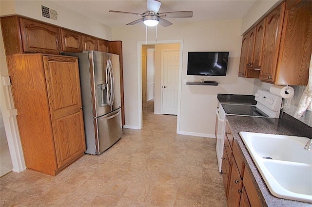 225 N Woodson Dr, Raymore, MO 64083 - kitchen featuring stainless steel fridge with ice dispenser, brown cabinets, a sink, and white electric range oven