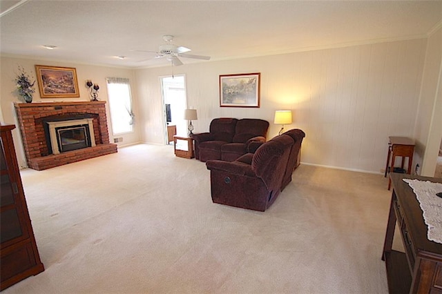 225 N Woodson Dr, Raymore, MO 64083 - living room with ornamental molding, ceiling fan, light carpet, and a fireplace