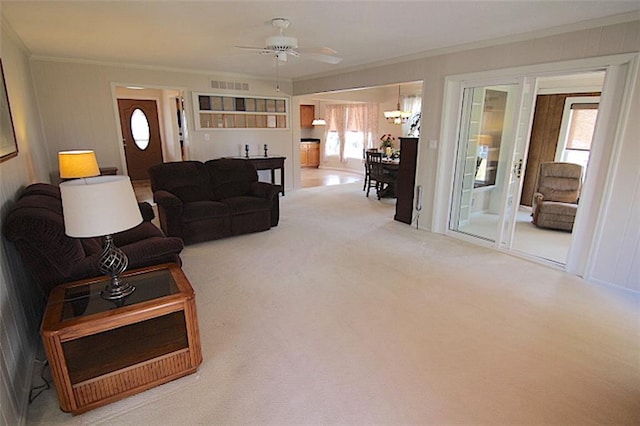 225 N Woodson Dr, Raymore, MO 64083 - living room featuring carpet flooring, visible vents, crown molding, and a healthy amount of sunlight