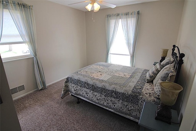 225 N Woodson Dr, Raymore, MO 64083 - bedroom with visible vents, baseboards, ceiling fan, and carpet