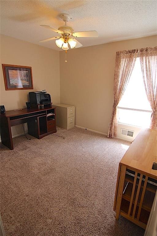 225 N Woodson Dr, Raymore, MO 64083 - home office with a textured ceiling, ceiling fan, carpet, and visible vents