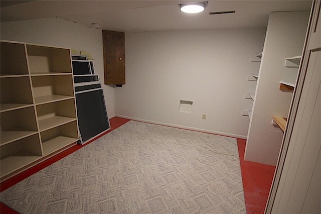225 N Woodson Dr, Raymore, MO 64083 - spare room featuring carpet flooring, visible vents, and baseboards