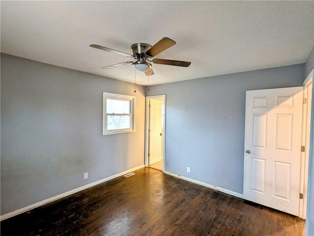 unfurnished bedroom with visible vents, a ceiling fan, a textured ceiling, wood finished floors, and baseboards