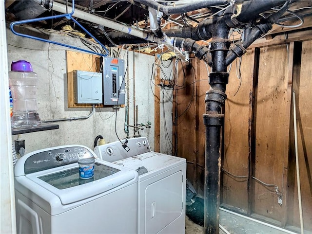 washroom featuring washer and clothes dryer, laundry area, and electric panel