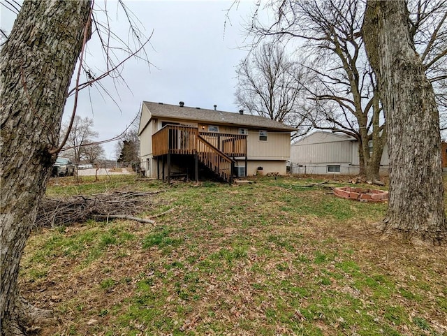 back of house with stairway, a lawn, and a deck