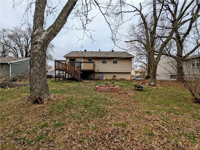 back of house with a deck, a yard, stairway, a fire pit, and crawl space