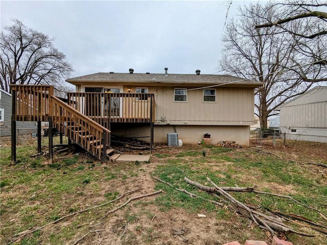 back of property with stairway, central air condition unit, a deck, and fence