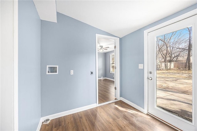 entrance foyer with baseboards, lofted ceiling, wood finished floors, and a ceiling fan