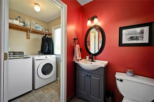 laundry area with a sink, independent washer and dryer, and laundry area