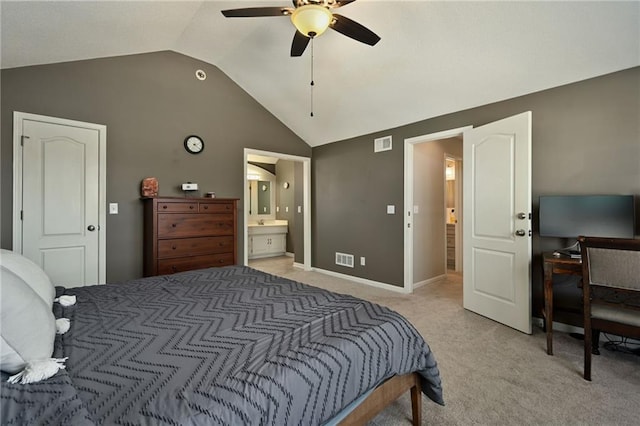 bedroom with visible vents, connected bathroom, baseboards, light colored carpet, and vaulted ceiling