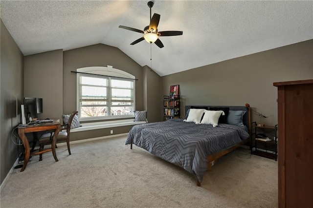 carpeted bedroom featuring baseboards, lofted ceiling, a textured ceiling, and ceiling fan