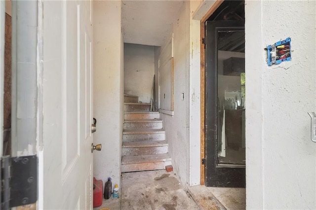 stairs featuring concrete floors