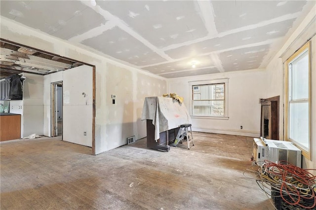 spare room with visible vents, a wealth of natural light, and a wall mounted AC