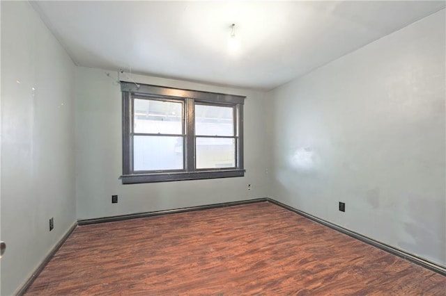 spare room featuring wood finished floors